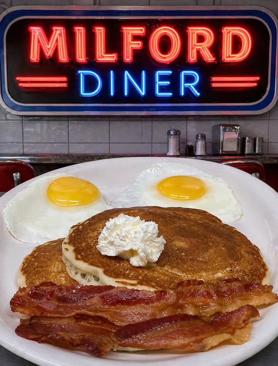 Milford Diner neon sign with classic eggs, pancakes and bacon breakfast plate